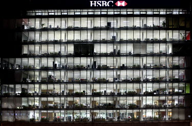 The HSBC building with offices lit up at night time in Geneva.