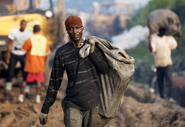 A man who scavenges for saleable items in the Olusosun dump carries a sack of items he has collected. The Olusosun dump is Nigeria's largest rubbish dump comprising over 100 acres of waste and is beli...