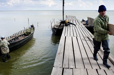 Fishermen on Lake Razim prepare for a day on the water. Most of the local fishermen are Lipovani, descendants of migrants who left Russia in the 18th Century to avoid religious persecution.