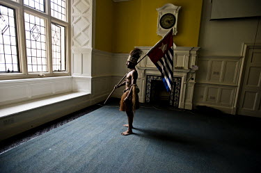Erisam Ap, an indigenous Papuan, holding a Morning Star flag (the flag adopted by Papuan nationalists), inside a building in Oxford University. Lawyers from all over the world convened here, in August...