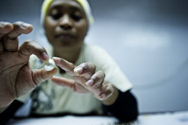 A worker grades cultured pearls at the Atlas South Sea Pearls farm in Chandana, Raja Ampat Islands.