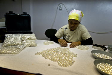 A worker grades cultured pearls at the Atlas South Sea Pearls farm in Chandana, Raja Ampat Islands.