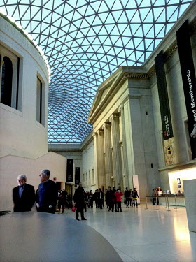 Visitors move around the Great Court in the centre of the British Museum in London.
