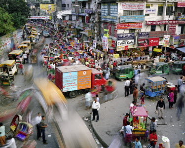 Rickshaws stand lined up waiting for customers and traffic passes at Tejturi Bazar in Farmgate in central Dhaka.