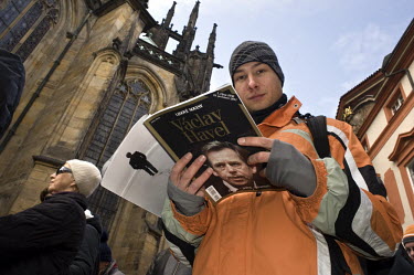 A man reads a special edition of Lidove Noviny, a Czech magazine with Vaclav Havel on the cover, while lining up to pay his respects in front of the coffin of Vaclav Havel in the Vladislave Hall of Pr...
