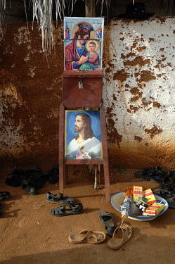 Picture of the Virgin Mary and Jesus stand on display near a donation box outside St Mary's church in the village of Fithi ('Justice')