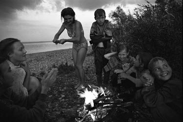 Children sit around a camp fire after going for a swim on the banks of the Volga River near Ulyanovsk.