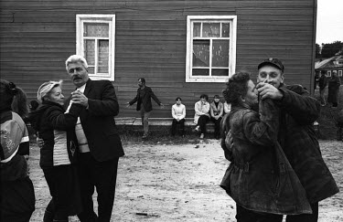 Couples dance in a village on the White Sea in the far North of Russia during a celebration. They belong to the Pomor (or Pomory - meaning 'maritime'), Russian settllers and their decendants who settl...