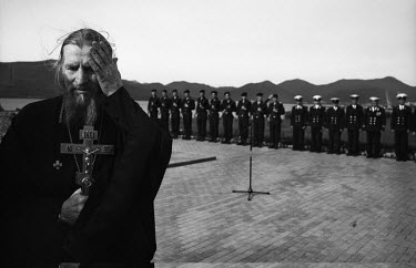 A priest officiates at a ceremony at a nuclear submarine base on the Kamchatka Peninsula in Russia's Far East.
