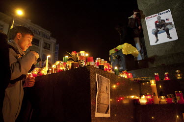 A man leaves a candle at the bottom of a statue on Wenceslas Square in Prague where people gathered to pay their respects to Vaclav Havel. Havel was a playwright, essayist and poet who became active a...