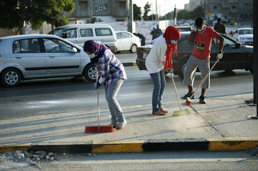 Young people clean up in the streets of Tripoli in the days following the removal of the Gadaffi regime.