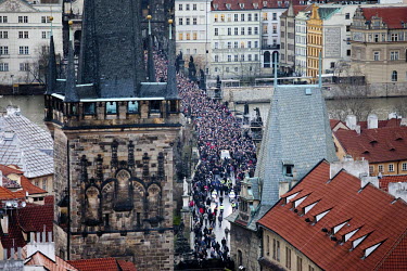A large crowd, estimated at 10,000 strong, accompanies the funeral cortege of Vaclav Havel across the Charles Bridge towards Prague Castle.