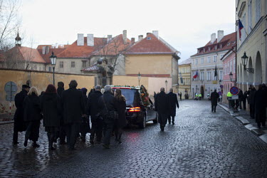 Family members and Vaclav Havel's closest friends follow the hearse containing the former presidents remains on its journey from the Old Town, across Charles Bridge, to Prague Castle.