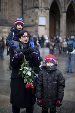 A woman stands with her two sons outside Prague Castle watching a broasdcast on a giant screen of the funeral of former president Vaclav Havel.