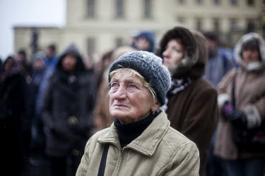 A woman outside Prague Castle watching a broasdcast on a giant screen of the funeral of former president Vaclav Havel.