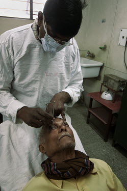 A man has his eye pressure measured in the Tata Main Hospital.