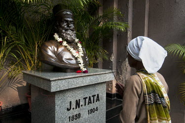 A woman performs a Puja before a bust of J.N. Tata at the Jusco office (Jusco is a Tata Steel administration, that maintains civic amenities and facilities in Jamshedpur and supports many community de...