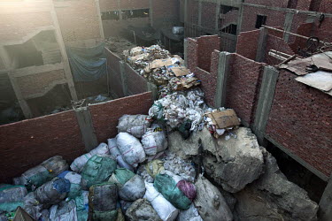 Bags of collected and sorted rubbish, piled up between apartment blocks in Madinat Nasr, waiting to be recycled. Cairo's rubbish is collected and recycled by a class of impoverished Coptic Christians...
