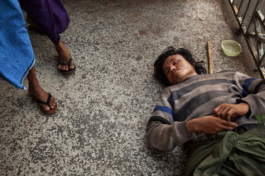 A homeless man begs for money in Yangon.