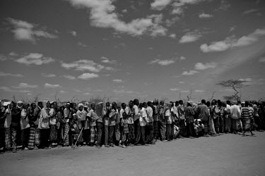 A queue of people line up for a food hand-out at the Dadaab refugee camp, the largest refugee complex in the world. The camp was originally set up at the start of Somalia's civil war in 1991 and was d...