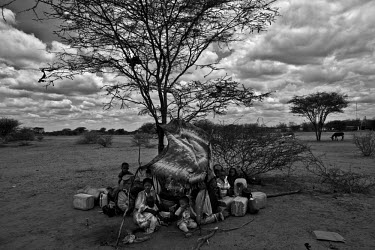 A family of Somalis sit among their possessions outside the Dadaab refugee camp. They have arrived after many days walking and now are waiting to be processed so they can enter the camp. Dadaab camp i...
