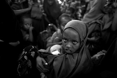 A girl queues up for a food hand-out at a World Food Program (WFP) distribution point in a camp for IDPs (internally displaced persons). The Horn of Africa is currently suffering the worst famine in 6...
