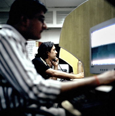 Workers at an international call centre in central Mumbai, they work an average 10-12 hours a day, 6 days a week.  Call centres have allowed thousands of young Indians to earn an impressive wage at a...