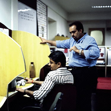 Manesh and his boss at an international call centre in Central Mumbai. He works an average 10-12 hours a day, 6 days a week.  Call centres have allowed thousands of young Indians to earn an impressive...
