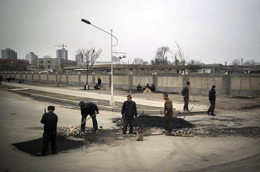 Construction workers repair a road in central Pyongyang.