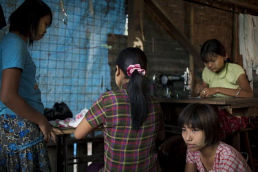 Women work in a small garment workshop in the constituency of NLD leader Aung San Suu Kyi where she competed and was voted in during a by-election in April 2012.