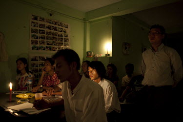 Students study by candlelight during a power cut at a civil society youth training session in Yangon (Rangoon).