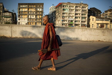 A monk walks near the docks in Yangon.