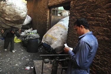 A man carries a huge sack of plastic, collected from throughout Cairo and destined for recycling by the Zaballeen, a minority group of Coptic Christians who have worked as Cairo's informal rubbish col...