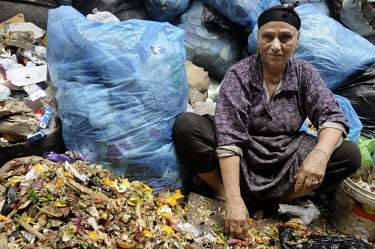 A woman sorts rubbish. The organic waste will be fed to pigs or used as a fertilliser while the other waste will be recycled. The woman is a Coptic Christian, known as a Zabaleen, a minority group who...