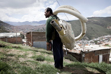 A man carries some tubing up a hill in the slum neighbourhood of Soacha, south of Bogota. Most of the people living here are internally displaced (IDPs).This story by Mads Nissen was partly funded by...
