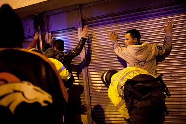 Local police officers search customers of a nightclub for drugs and weapons. Violence and crime rates are high in the slums south of Bogota. Most of the residents in this area are internally displaced...