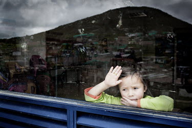A child looks through a glass window in the slum neighbourhood of Soacha, south of Bogota. Most of the people who live here are internally displaced (IDPs).This story by Mads Nissen was partly funded...