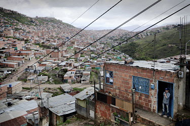 A man looks out from his shack with a view over the slum area of Soacha, south of Bogota. Most of the people who live here are IDPs.This story by Mads Nissen was partly funded by a grant and when publ...