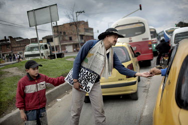 A displaced (IDP) man and his son beg for money from passing traffic in the slum neighbourhood of Soacha, south of Bogota.This story by Mads Nissen was partly funded by a grant and when published it s...