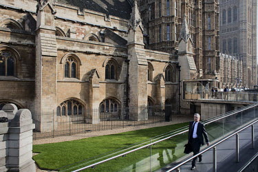 A visitor enters the Houses of Parliament in Westminster, London.