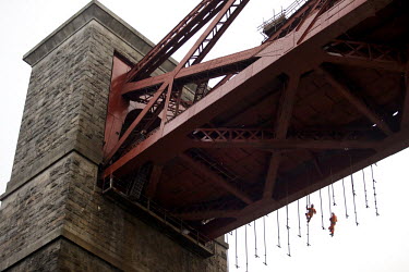 Workers dismantle the scaffolding on the 125 year old Forth Rail Bridge which spans the river Forth near Edinburgh. Network Rail, the operator of the rail track that leads over the bridge, has spent 1...