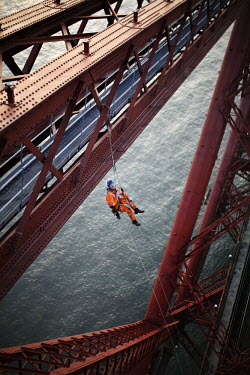 Abseiler preparing to carry out touch points from the top of the Fife cantilever on the 125 year old Forth Rail Bridge which spans the river Forth near Edinburgh. Network Rail, the operator of the rai...