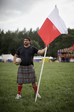 Sebastian Wenta is a Polish shot put champion, three time winner of the World Highland championship and was second in the World's Strongest Man 2007. Here he stands holding the Polish flag at the Call...