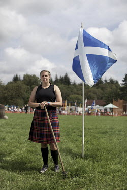 Stacey Wilson, of Scotland, is a champion hammer, shot and discus thrower. She stands next to a Scottish flag at the Callander Highland Games, Stirlingshire.