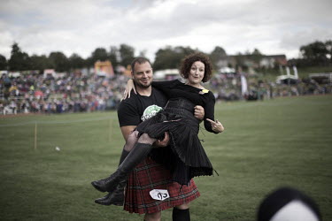 Gregor Edmunds from Scotland has been world caber tossing champon, No 1 Highland Games athlete in the world and World Highland Games champion 2007. Here seen carrying Chieftain Blythe Duff, a UK TV pe...