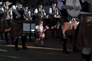A child participates in the final 'Massing of the pipes' which completes the Cowal Gathering, Scotland's largest Highland Games, in Dunoon, Argyl and Bute.