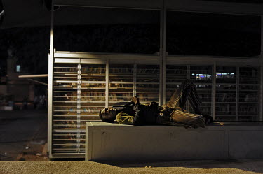 A man rests at night in Levinsky Garden, at the heart of a neighbourhood hosting African asylum seekers.