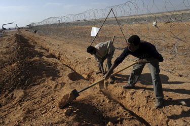 Eritrean labourers working for an Israeli construction company, at the construction site of a barrier at the Israel-Egypt border, some 70 km north of Eilat. Alarmed by what it described as a near-doub...
