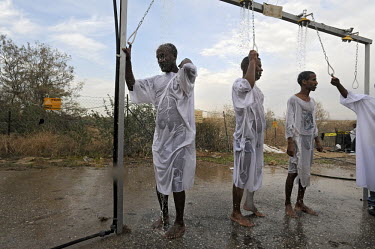 Eritrean asylum seekers, who reside in Israel, baptize in showers with water taken from the Jordan River, at the baptismal site of Qasr el Yahud, the spot where John the Baptist is said to have baptiz...