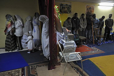 Eritrean asylum seekers conduct a prayer at their makeshift church.